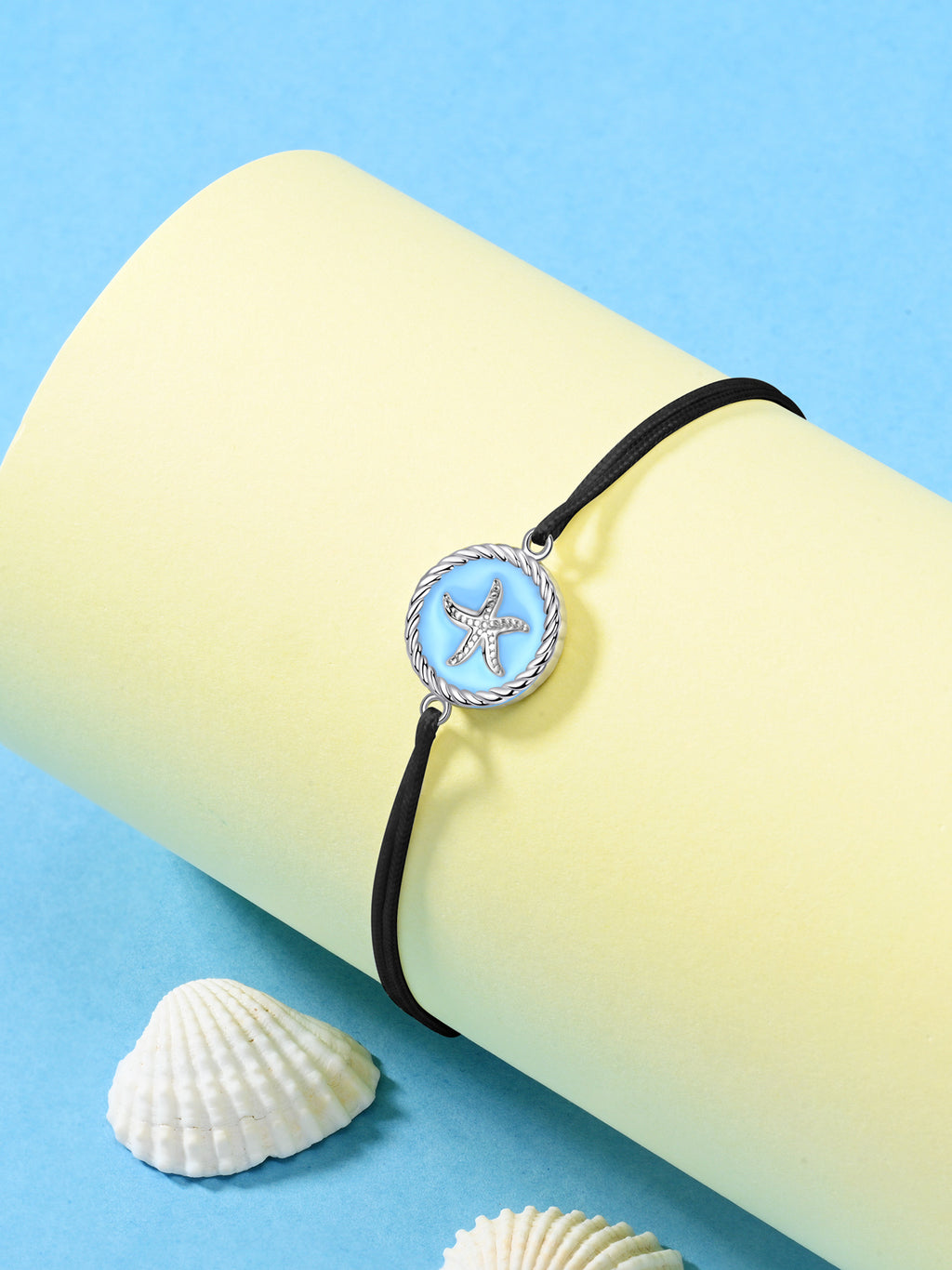 Black starfish string anklet with blue enamel silver charm on yellow cylinder, seashells decoration