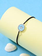 Black starfish string anklet with blue enamel silver charm on yellow cylinder, seashells decoration